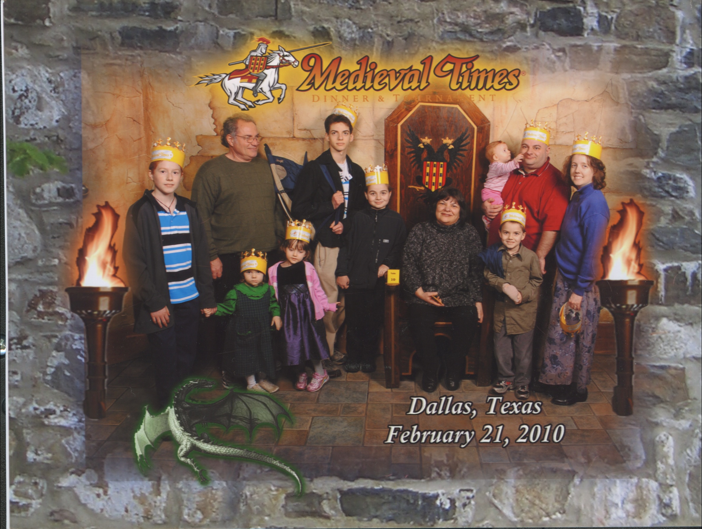 Medieval Times Throne Room. Michael, Grandfather 'Nunu', Bernie Jacinta, Joseph, Nunzio, Grandmother 'Nana' sitting on a throne, Justin holding Catie, Cross and Jen. Bottom Text: 'Dallas, Texas February 21, 2010'