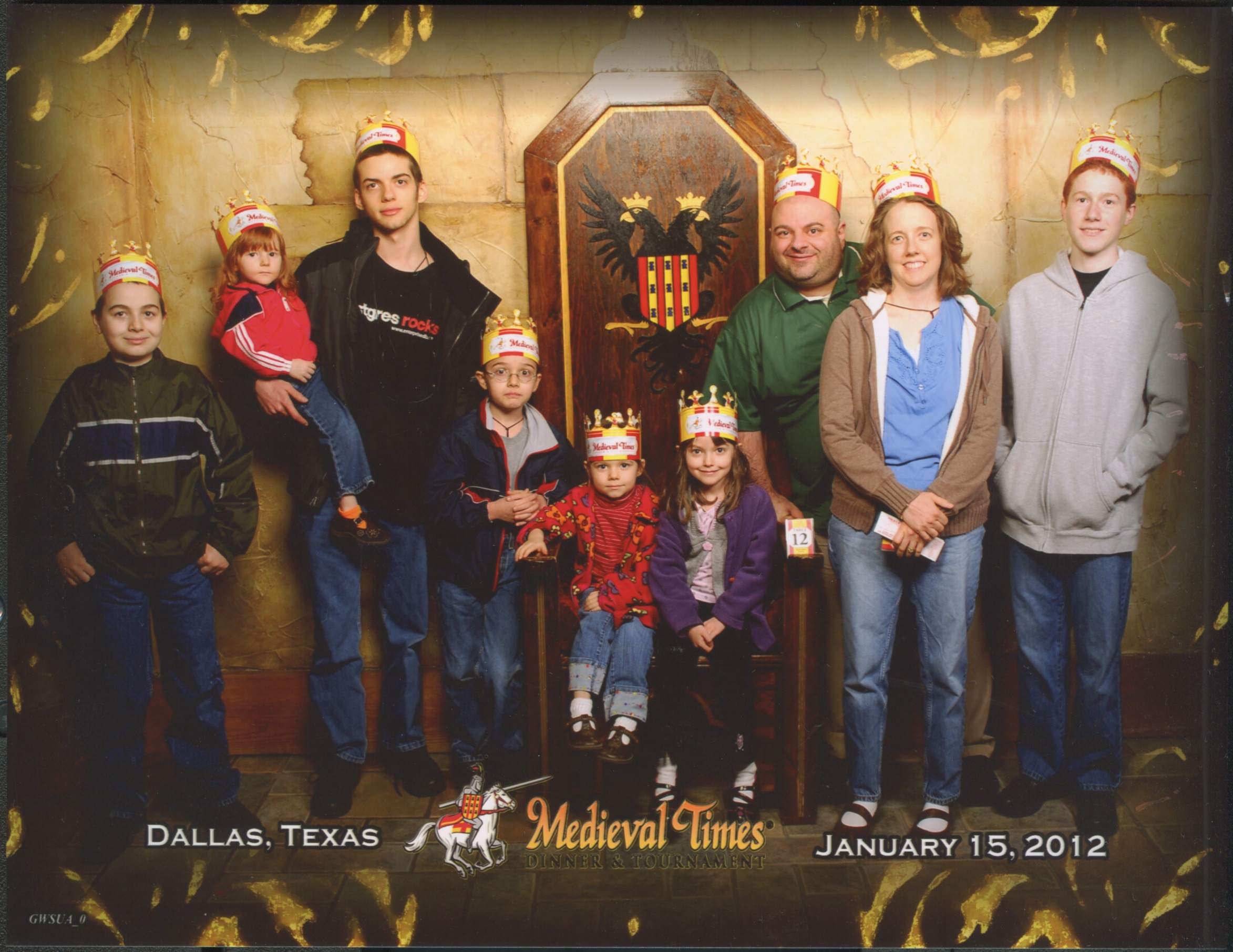 Medieval Times Throne Room. Nunzio, Joseph holding Catie, Cross, Bernie, Jacinta, Justin, Jen and Michael. Bottom Text: 'Dallas, Texas January 15, 2012'