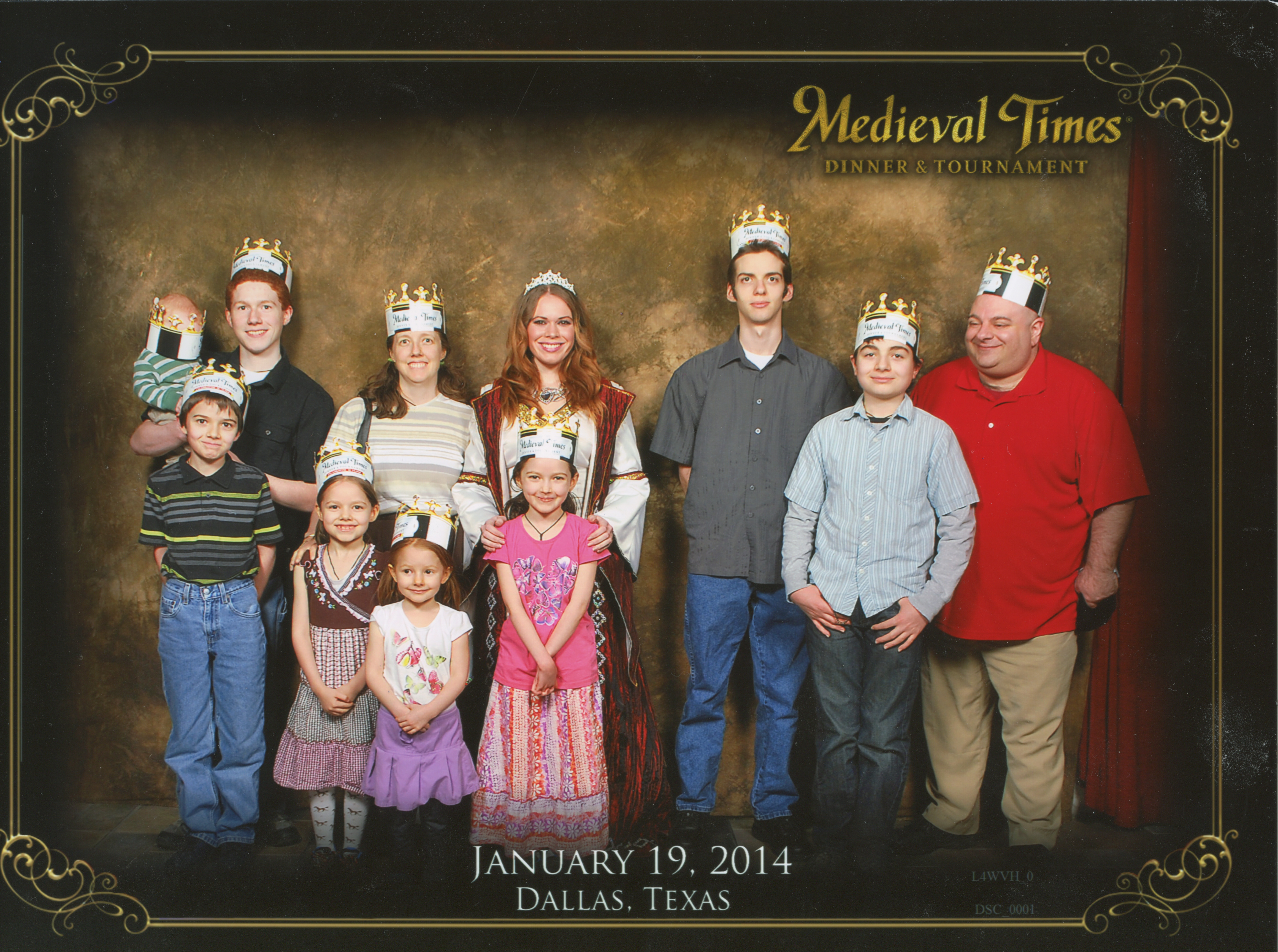 Medieval Times Stone Wall Background. Michael holding Becket who has his mock paper crown which is too big for him fall down and block his vision like a paper blindfold. It's hilarious. Cross, Bernie, Jen, Catie, The Princess, Jacinta, Joseph Nunzio and Justin. Bottom Text: 'Dallas, Texas January 19, 2014'