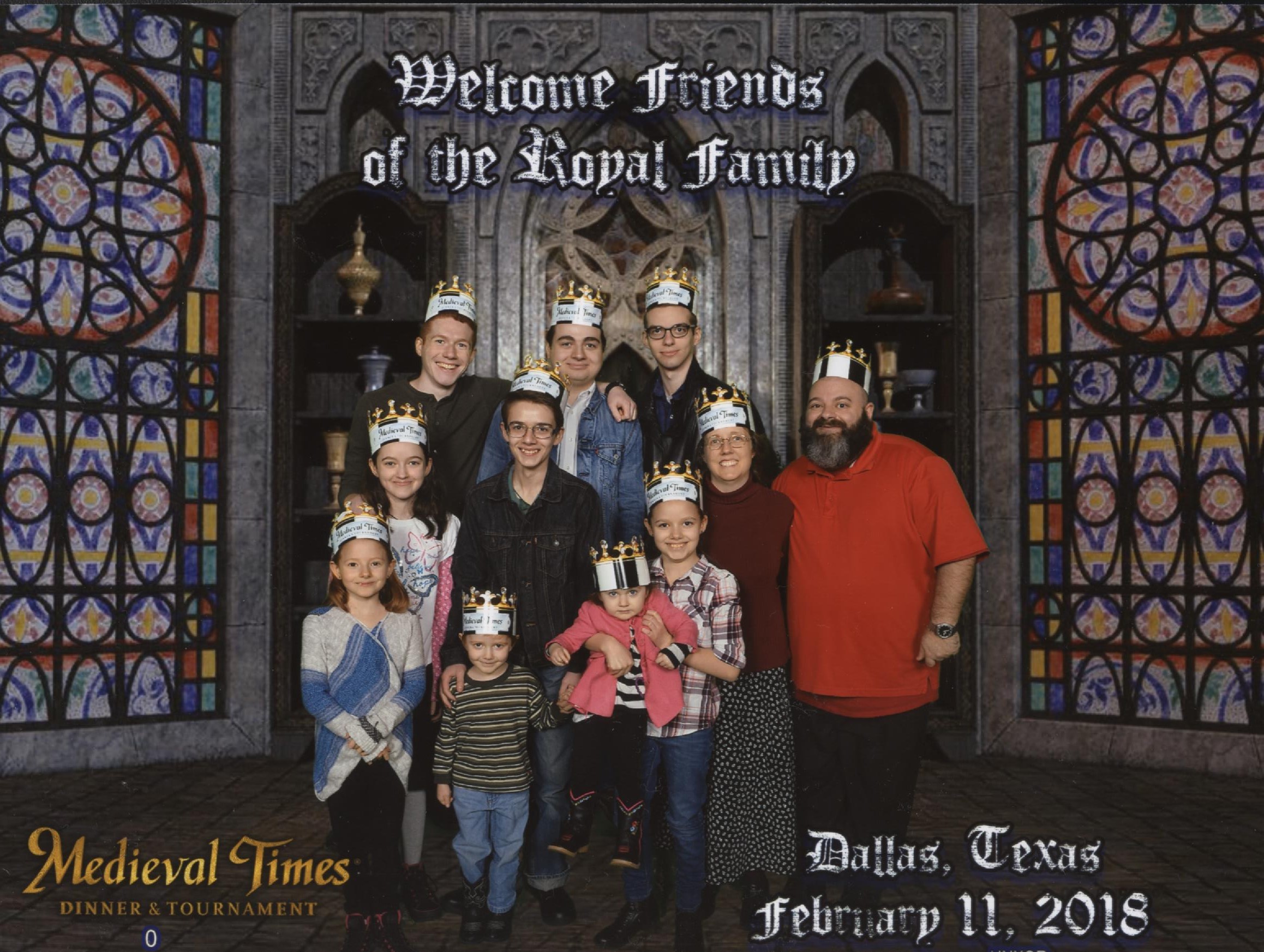 Medieval Times Stained Glass Windows Background. Top Text: 'Welcome friends of the Royal family.' Catie, Jacinta, Michael, Becket, Cross, Nunzio, Bernie holding Cecilia, Joseph, Nunzio, Jen and Justin! Bottom Text: 'Dallas, Texas February 11, 2018'